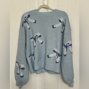 NWOT Women’s Whimsical Blue and White Crew Neck Sweater with Bow Motif.